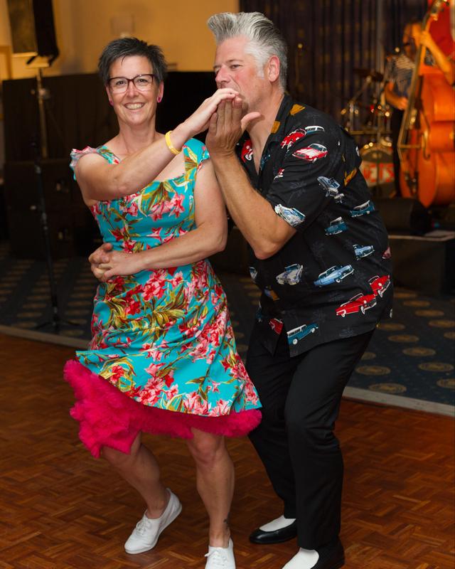 A couple laughing as they dance